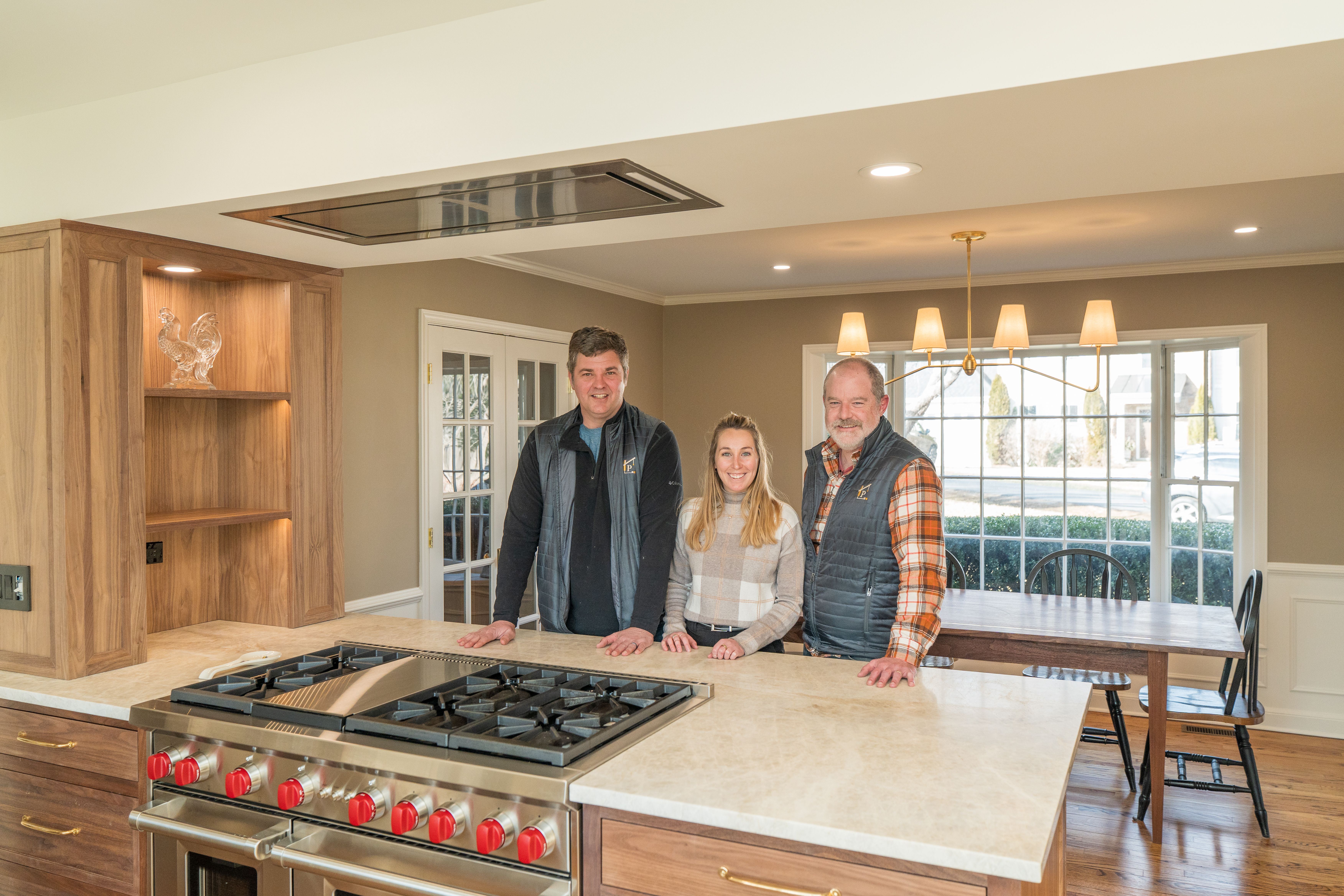The architecture team pictured in a remodeled kitchen
