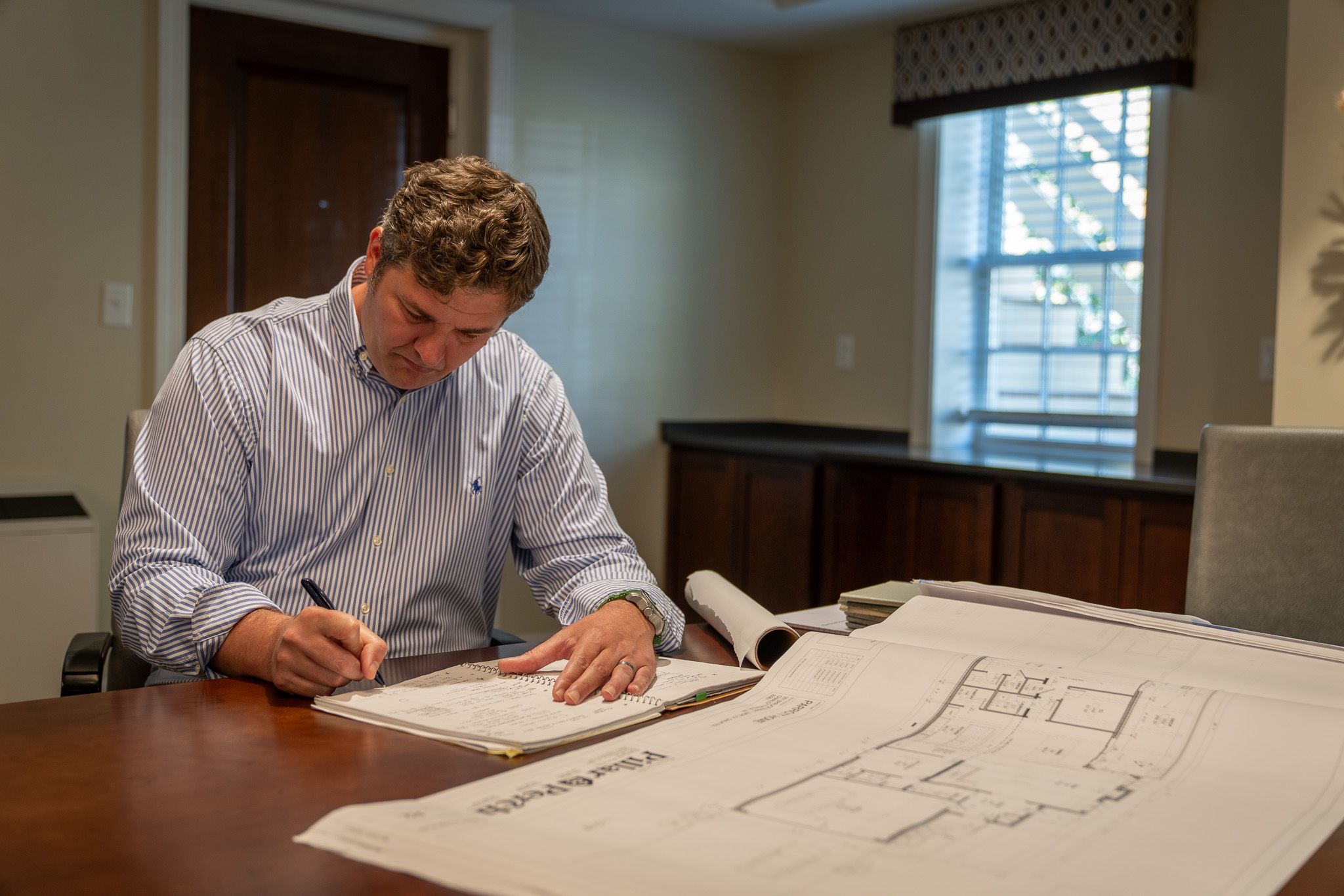 Architect drawing and looking at plans